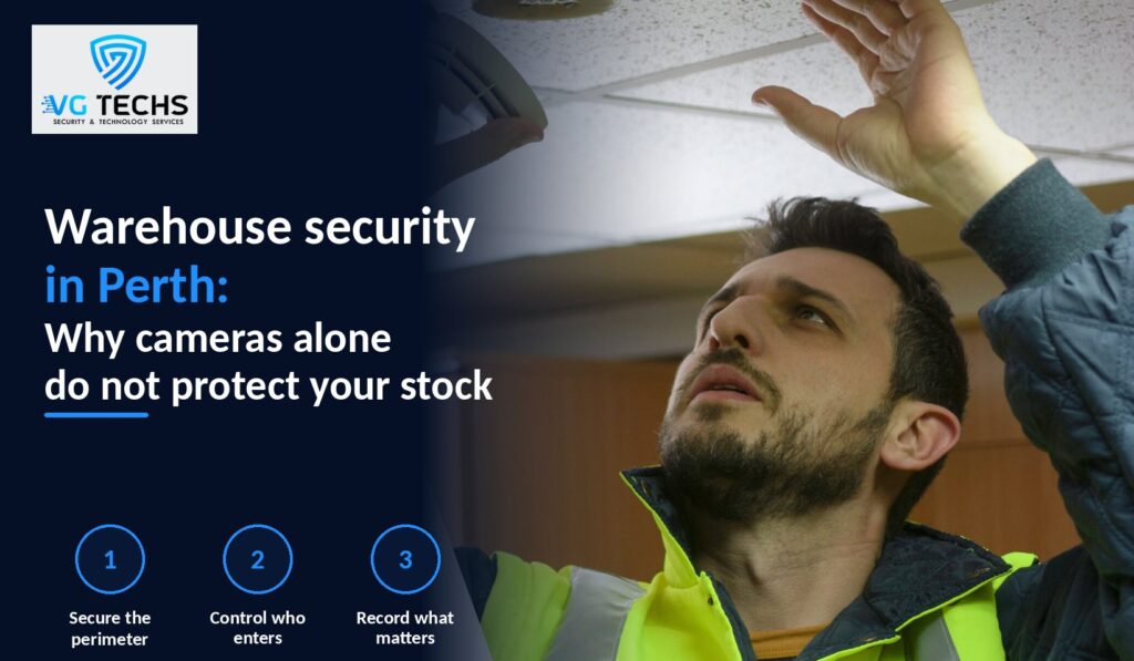 Technician in a high-visibility vest inspecting a ceiling-mounted security sensor in a Perth warehouse